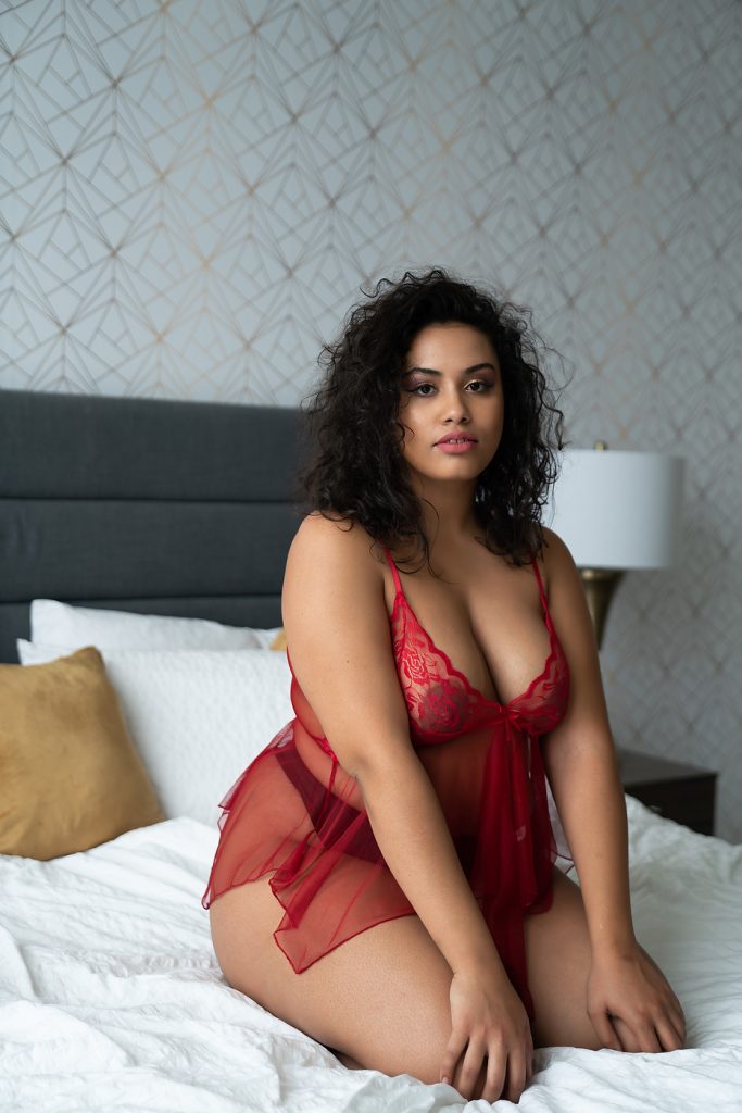 client wearing red babydoll lingerie for her boudoir photo session