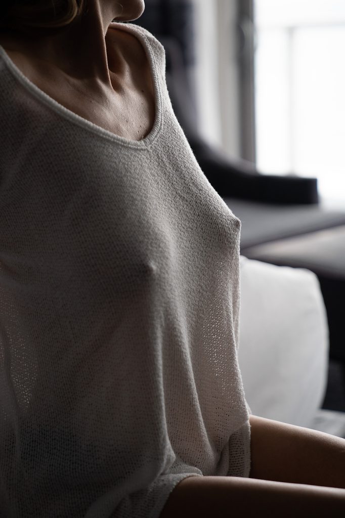 a client wearing a thin sweater for a sensual vibe for her bousoir photo session